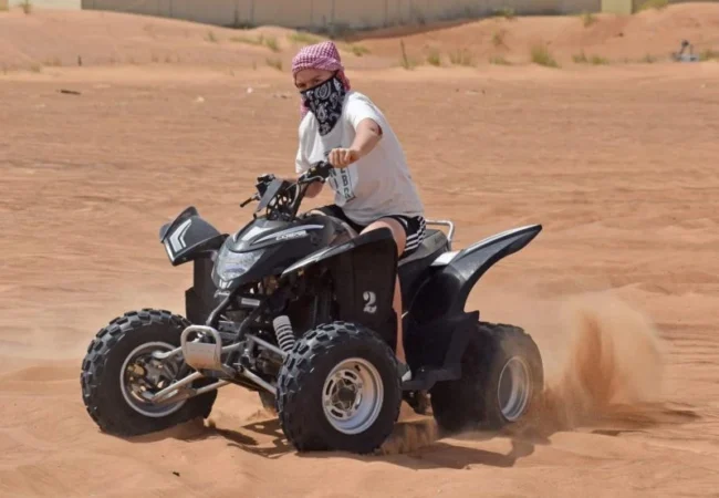 Yamaha 220cc beginner quad bike parked on red sand near Dubai