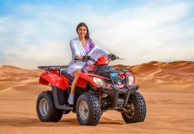 Yamaha 400cc quad bike on a dune ridge in the Dubai desert